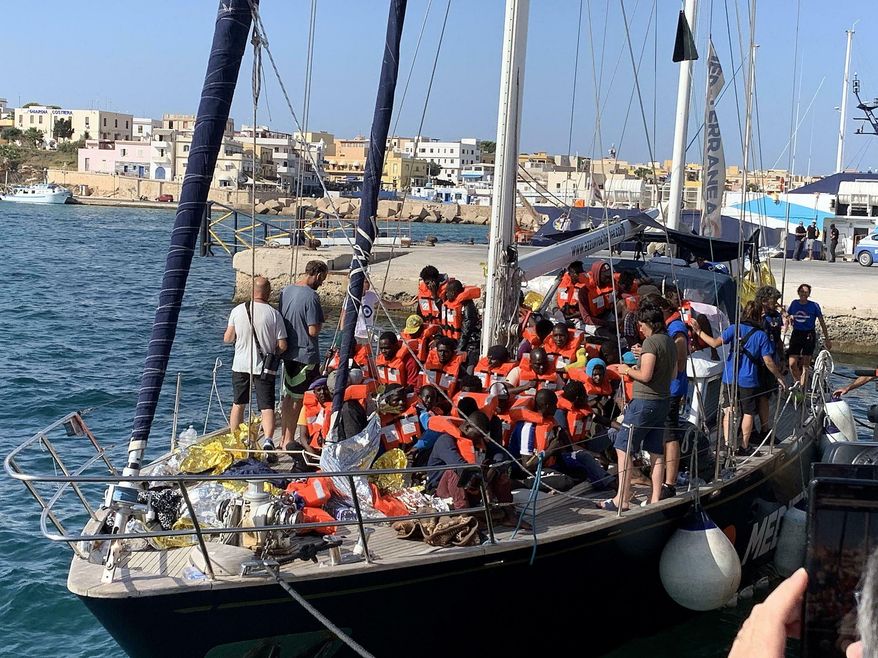 The Italian NGO Mediterranea Saving Humans' Alex migrant rescue ship carrying 46 migrants rescued off Libya coasts, docks in the port of Lampedusa, Sicily island, Italy, Saturday, July 6, 2019. Italy’s hard-line interior minister, Matteo Salvini, has barred all private rescue ships from entering Italian ports. He pointed to an offer from Malta to accept the migrants from the Italian-flagged ship. (Elio Desiderio/ANSA via AP)