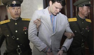 FILE - In this March 16, 2016, file photo, American student Otto Warmbier, center, is escorted at the Supreme Court in Pyongyang, North Korea. Warmbier&#39;s parents have filed a claim for the North Korean cargo ship seized in May 2019 by the United States in a bid to collect a $500 million judgment awarded in the American college student&#39;s death. Otto Warmbier was imprisoned in North Korea for months after being convicted of trying to steal a propaganda poster and died days after being returned to the U.S. in a vegetative state in June 2017. (AP Photo/Jon Chol Jin, File)