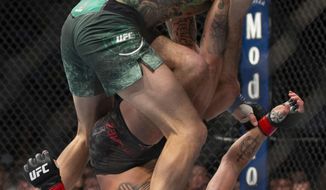 Diego Sanchez, bottom, defends himself against Michael Chiesa during their welterweight mixed martial arts bout at UFC 239, Saturday, July 6, 2019, in Las Vegas. Chiesa won by unanimous decision. (AP Photo/Eric Jamison)