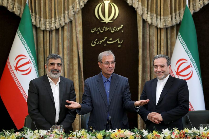 Iranian Deputy Foreign Minister Abbas Araghchi (right) says Iran considers the 2015 nuclear deal to be a "valid document." He's pictured here with atomic agency spokesman Behrouz Kamalvandi (left) and government spokesman Ali Rabiei. (ASSOCIATED PRESS)