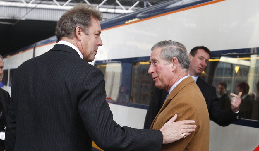 Britain's Ambassador to the EU Kim Darroch, left, welcomes Britain's Prince Charles upon his arrival at Brussels Midi train station in Brussels, Wednesday, Feb. 13, 2008. Prince Charles is on a two-day visit to European Union institutions. (AP Photo/Thierry Roge, Pool)