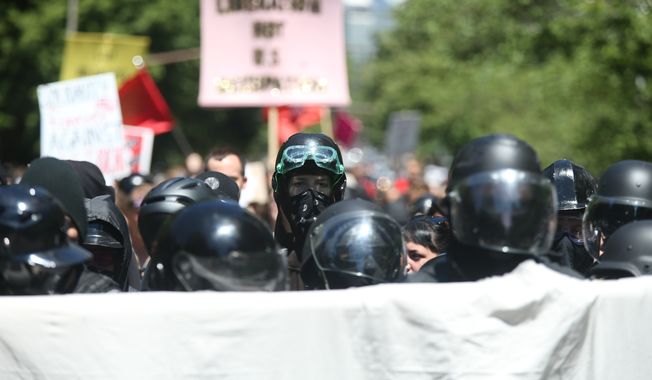 Multiple groups, including Rose City Antifa, the Proud Boys and conservative activist Haley Adams protest in downtown Portland, Ore., Saturday, June 29, 2019. (Dave Killen/The Oregonian via AP) ** FILE **