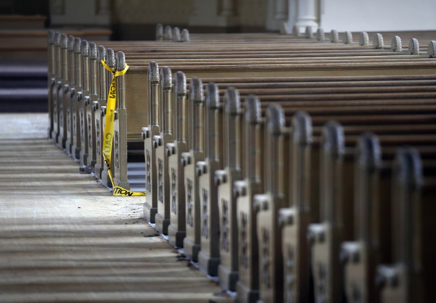 Caution tape hangs from a pew in the St. Andre's Catholic Church in Biddeford, Maine, Thursday, July 24, 2014. The church, which opened in 1900, has sat empty for four years. (AP Photo/Robert F. Bukaty) **FILE**
