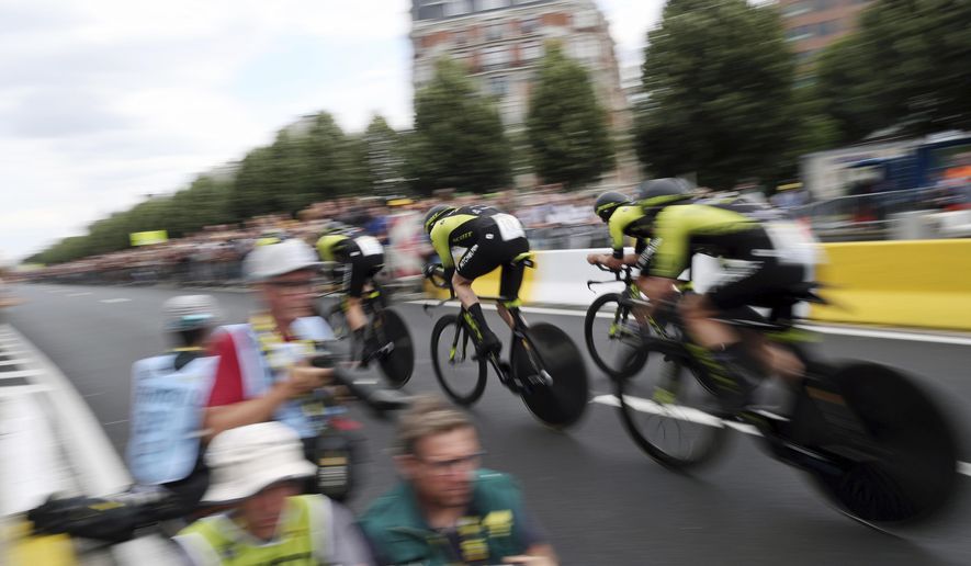 Mitchelton Scott team strains during the second stage of the Tour de France cycling race, a team time trial over 27.6 kilometers (17 miles) with start and finish in Brussels, Belgium, Sunday, July 7, 2019. (AP Photo/Thibault Camus)