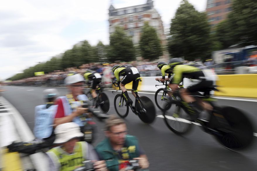Mitchelton Scott team strains during the second stage of the Tour de France cycling race, a team time trial over 27.6 kilometers (17 miles) with start and finish in Brussels, Belgium, Sunday, July 7, 2019. (AP Photo/Thibault Camus)