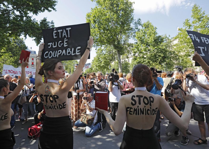 Femen activists hold placards during a rally against women violence in Paris, Saturday, July 6, 2019. France has registered more than 70 such alleged killings so far his year, according to a Facebook group tracking them. The current government has promised to accelerate measures to protect abused women. Placards read, left, 'state is guilty', right, 'stop to femicide'. (AP Photo/Michel Euler)