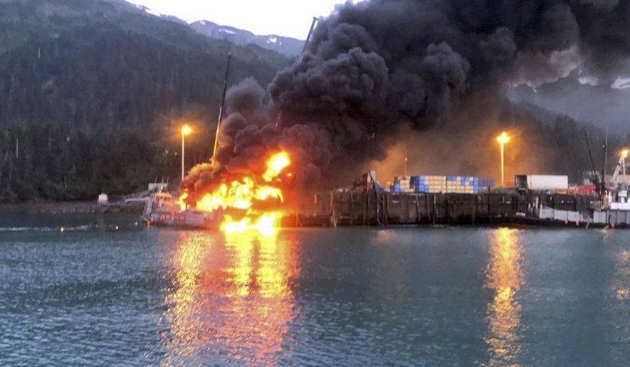 This photo provided by the U.S. Coast Guard shows the fishing boat Alaganik burning at a dock in Whittier, Alaska, in the early morning hours of Monday, July 8, 2019. The Coast Guard says a propane tank exploded around midnight Sunday on the 99-foot (30-meter) fishing vessel at a dock operated by the city of Whittier. The boat burned and sank at the dock. (U.S. Coast Guard via AP)