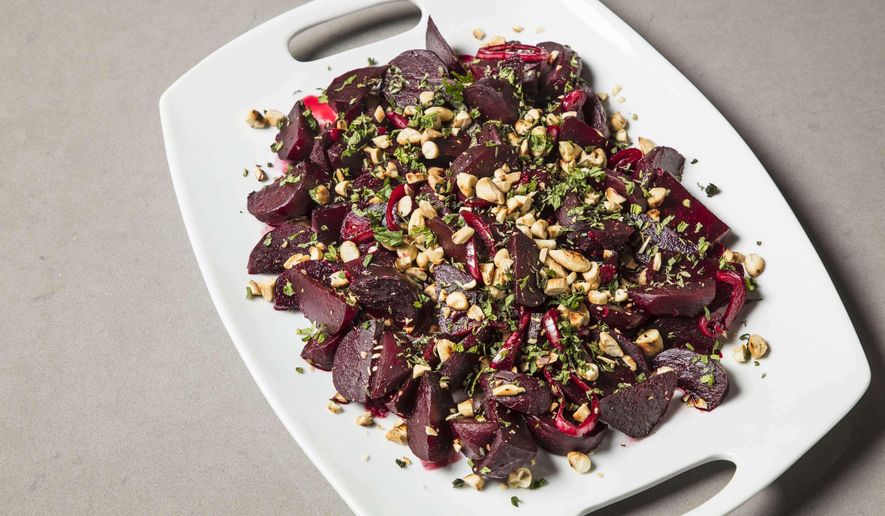 This undated photo provided by America's Test Kitchen in June 2019 shows Braised Beets with Lemon and Almonds in Brookline, Mass. This recipe appears in the cookbook "Vegetables Illustrated." (Daniel J. van Ackere/America's Test Kitchen via AP)