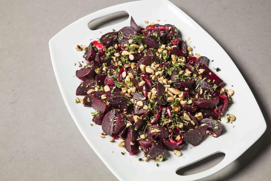 This undated photo provided by America's Test Kitchen in June 2019 shows Braised Beets with Lemon and Almonds in Brookline, Mass. This recipe appears in the cookbook "Vegetables Illustrated." (Daniel J. van Ackere/America's Test Kitchen via AP)