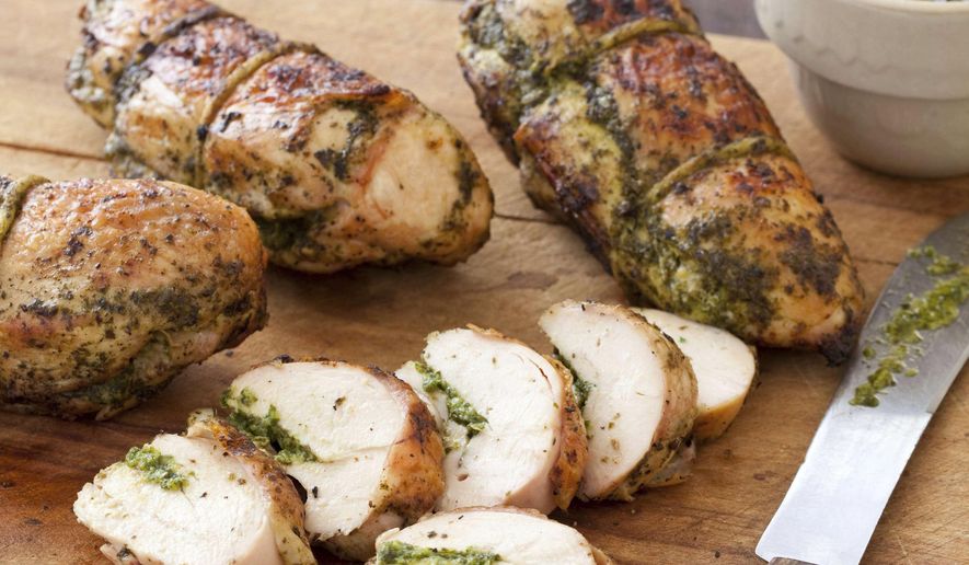 This undated photo provided by America's Test Kitchen in June 2019 shows Grilled Pesto Chicken in Brookline, Mass. This recipe appears in the cookbook "Master of the Grill." (Joe Keller/America's Test Kitchen via AP)