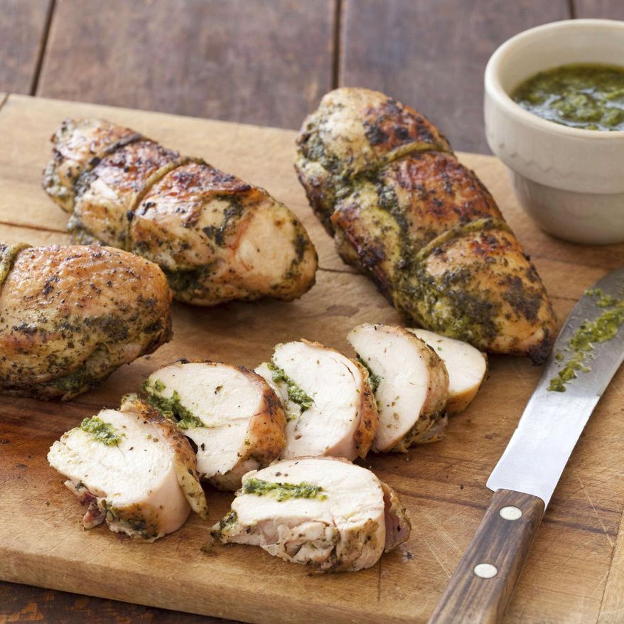 This undated photo provided by America's Test Kitchen in June 2019 shows Grilled Pesto Chicken in Brookline, Mass. This recipe appears in the cookbook "Master of the Grill." (Joe Keller/America's Test Kitchen via AP)