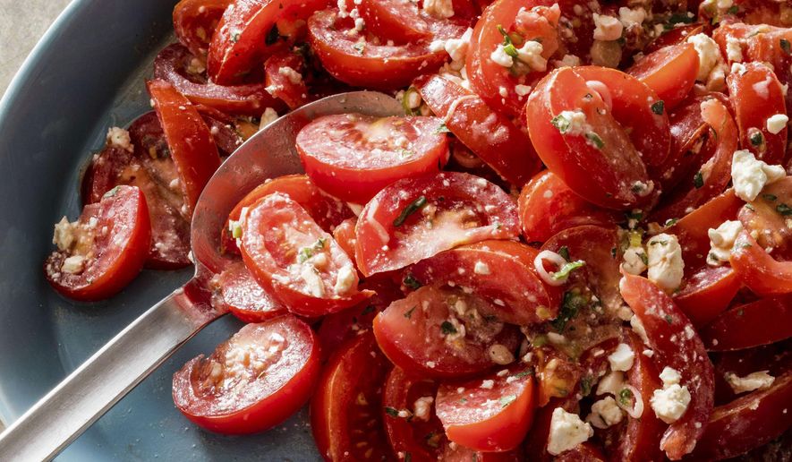 This undated photo provided by America's Test Kitchen in June 2019 shows a Tomato Salad with Feta and Cumin-Yogurt Dressing in Brookline, Mass. This recipe appears in "The Complete Mediterranean Cookbook." (Daniel J. van Ackere/America's Test Kitchen via AP)