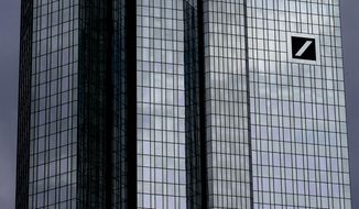 Dark clouds reflect in the facade of the headquarters of Deutsche Bank in Frankfurt, Germany, Sunday, July 7, 2019. The supervisory board of the bank meets on Sunday to decide about further strategies. (AP Photo/Michael Probst)