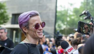 United States women&#39;s soccer team member Megan Rapinoe speaks to the media upon her arrival at a hotel Monday, July 8, 2019, in New York. The city will honor the team with a parade Wednesday for their fourth Women&#39;s World Cup victory. (AP Photo/Corey Sipkin)