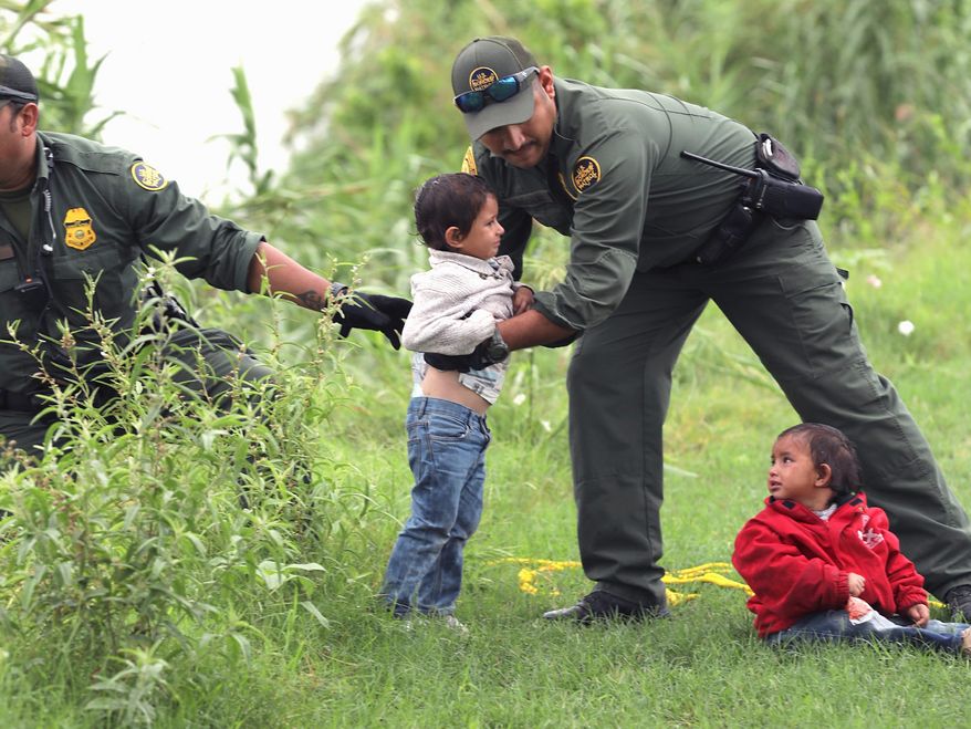 Border Patrol Agents rescue two children near Eagle Pass, Texas. A Texas Republican says stories about abuse at the border aren't true. (Associated Press)