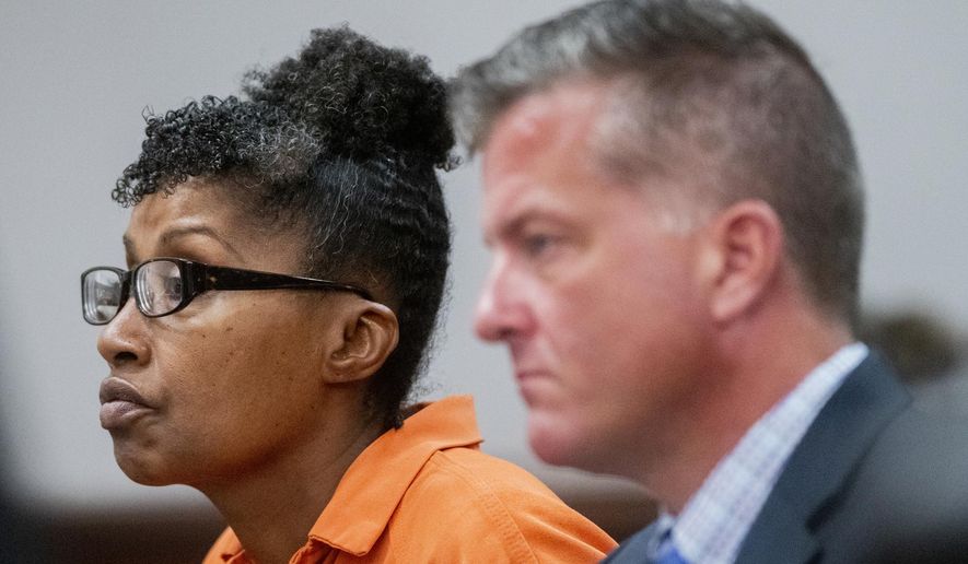 Jacquelyne F. Tyson, a 57-year-old Grand Blanc woman, left, listens to Genesee County Circuit Court Judge Joseph J. Farah alongside defense attorney Michael Ewing, right, at Genesee County Circuit Court, Tuesday, July 9, 2019, in downtown Flint, Mich. Farah ruled Tyson is found guilty of single counts of first-degree murder and second-degree murder for the July 2016 shooting deaths of Tamara Johnson and Lyric Work, in the leasing office at a Grand Blanc apartment complex. (Jake May/MLive.com/The Flint Journal via AP)