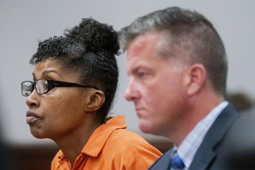 Jacquelyne F. Tyson, a 57-year-old Grand Blanc woman, left, listens to Genesee County Circuit Court Judge Joseph J. Farah alongside defense attorney Michael Ewing, right, at Genesee County Circuit Court, Tuesday, July 9, 2019, in downtown Flint, Mich. Farah ruled Tyson is found guilty of single counts of first-degree murder and second-degree murder for the July 2016 shooting deaths of Tamara Johnson and Lyric Work, in the leasing office at a Grand Blanc apartment complex. (Jake May/MLive.com/The Flint Journal via AP)