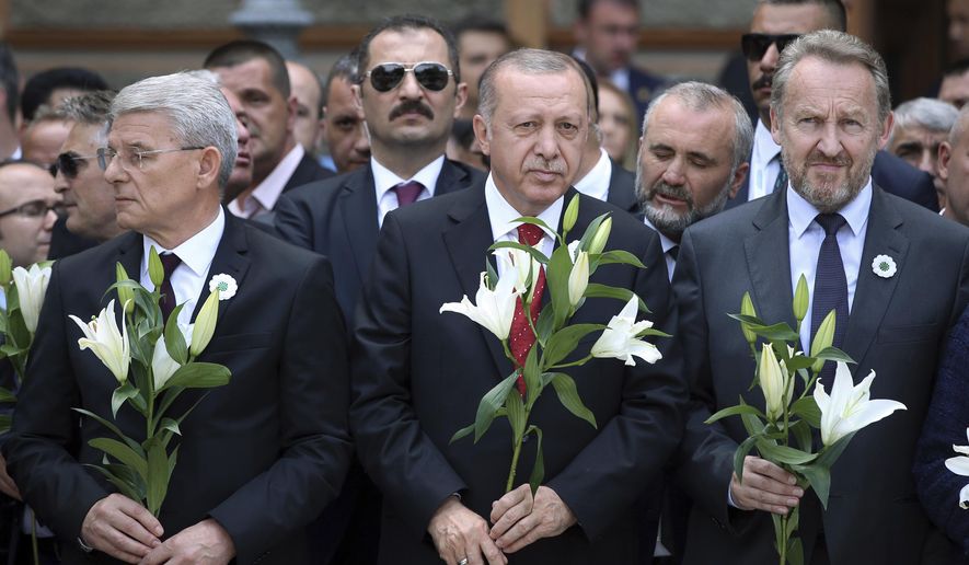 Turkish President Recep Tayyip Erdogan, center, Sefik Dzaferovic, Muslim member of Bosnian presidency, left, and Bakir Izetbegovic, the son of late Bosnian president Alija Izetbegovic, attend an event in memory of Bosnian Muslims from the eastern Bosnian town of Srebrenica, who were killed during the war in the 1990s in the worst massacre in Europe since World War II., in Sarajevo, Bosnia, Tuesday, July 9, 2019. (Presidential Press Service via AP, Pool)