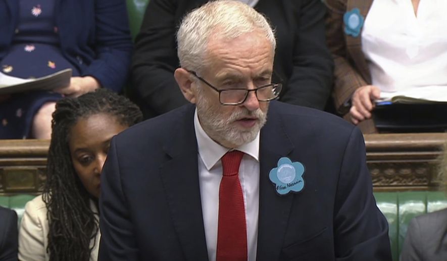 Britain's main opposition Labour Party leader Jeremy Corbyn wears a "Free Nazanin" badge as he speaks during Prime Minister's Questions session at the House of Commons in London, Wednesday June 26, 2019. Nazanin Zaghari-Ratcliffe is a British-Iranian dual citizen who has been imprisoned in Iran for over three years. (House of Commons TV / PA via AP)
