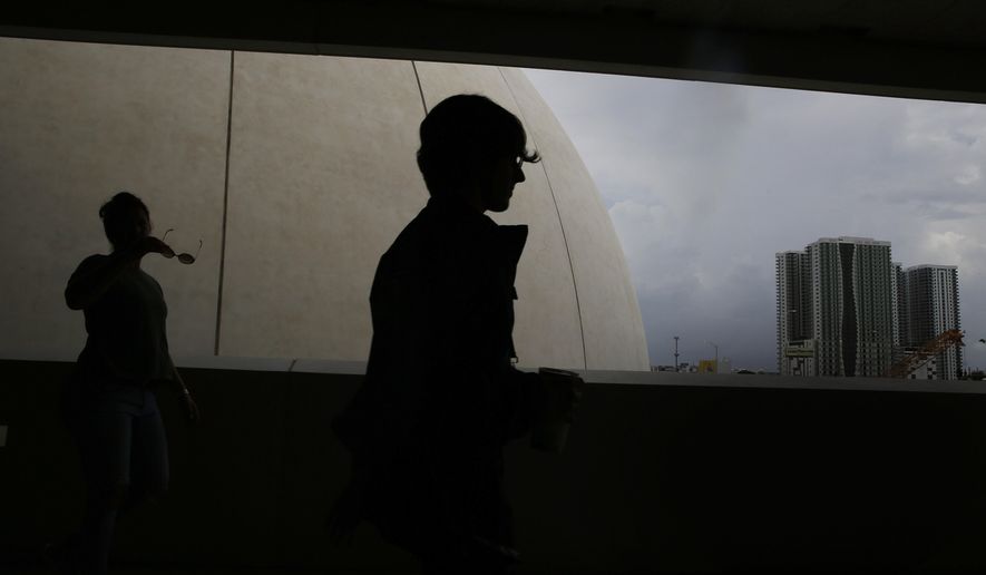 FILE - In this June 9, 2019, file photo museum goers walk through the Phillip and Patricia Frost Museum of Science in Miami. After student loan payments, rent and the rest, millennials may feel they don’t have enough money left to invest. But that doesn’t have to be the case. (AP Photo/Brynn Anderson, File)