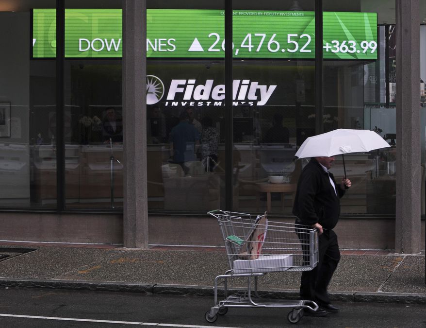 In this June 18, 2019, file photo, a man pulls a grocery cart as he walks in the rain past the stock ticker scroll board, showing a strong daily gain in the Dow Jones, outside Fidelity Investments in the Financial District of Boston. According to a survey by The Associated Press-NORC Center for Public Affairs Research, Americans are generally satisfied with their personal finances, but many lack confidence in their ability to afford retirement, an emergency expense or even their daily living costs (AP Photo/Charles Krupa)