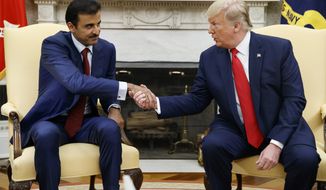 President Donald Trump shakes hands with Qatar&#39;s Emir Sheikh Tamim Bin Hamad Al-Thani in the Oval Office of the White House, Tuesday, July 9, 2019, in Washington. (AP Photo/Evan Vucci)