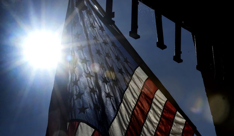 The sun rises behind an American flag posted outside of Petrunik&#x27;s Kitchen, Door and Moore store at the old Eureka Department store in Windber, Pa., Wednesday, July 10, 2019. (Todd Berkey/The Tribune-Democrat via AP) ** FILE **