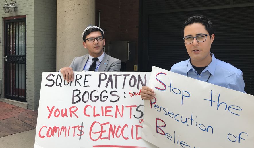 Salih Hudayar (left) and Kyle Olbert rally outside the Squire Patton Boggs offices in D.C. on Wednesday. Save the Persecuted Christians organized demonstrations calling on the firm to stop representing governments that persecute religious minorities. (Photo by Christopher Vondracek/ The Washington Times)