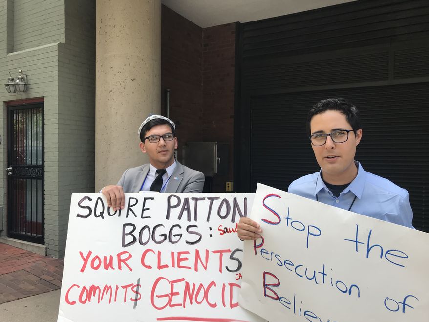 Salih Hudayar (left) and Kyle Olbert rally outside the Squire Patton Boggs offices in D.C. on Wednesday. Save the Persecuted Christians organized demonstrations calling on the firm to stop representing governments that persecute religious minorities. (Photo by Christopher Vondracek/ The Washington Times)