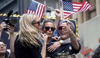 U.S. women&#39;s soccer team players Allie Long, left, Ashlyn Harris, center, and Megan Rapinoe celebrates during a ticker tape parade along the Canyon of Heroes, Wednesday, July 10, 2019, in New York. The U.S. national team beat the Netherlands 2-0 to capture a record fourth Women&#39;s World Cup title. (AP Photo/Craig Ruttle) **FILE**