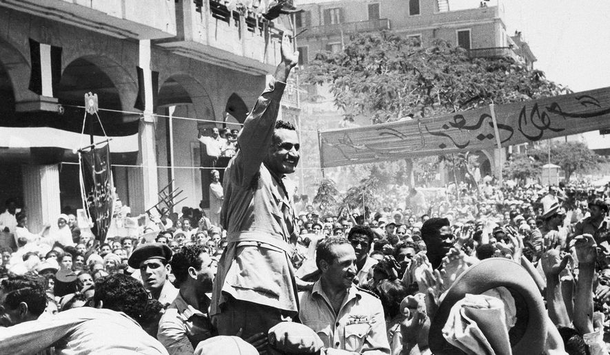 FILE - In this June 18, 1956 file photo, Egyptian leader Gamal Abdel Nasser waves as he moves through Port Said, Egypt, during a ceremony in which Egypt formally took over control of the Suez Canal from Britain. The resignation of the United Kingdom’s ambassador to the United States is a rare instance of a souring in relations between the Trans-Atlantic allies, though there have a few nadirs over the decades. One of the most serious crises to beset London and Washington came at the crossroads of a dying British empire and the exponential growth of America as a superpower in the wake of World War II. In 1956 in the Suez Canal, which connects the Mediterranean Sea and the Red Sea, Egypt’s pan-Arab leader, Gamal Abdel Nasser, nationalized the canal to Britain’s fury (AP Photo,File)