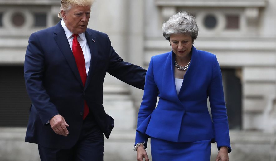 FILE - In this Tuesday, June 4, 2019 file photo, Britain's Prime Minister Theresa May and President Donald Trump walk through the Quadrangle of the Foreign Office for a joint press conference in central London. The resignation of the United Kingdom’s ambassador to the United States is a rare instance of a souring in relations between the Trans-Atlantic allies, though there have a few nadirs over the decades. Trump has made clear his displeasure over outgoing Prime Minister Theresa May’s handling of Britain’s exit from the European Union. His sharp criticism over the past three years, that she didn’t follow his advice, seem to have been tempered when he was welcomed on a state visit this spring. (AP Photo/Frank Augstein, file)