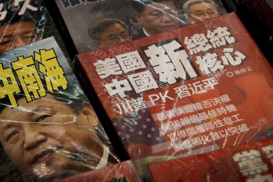 In this Thursday, July 4, 2019, photo, magazines with a front cover featuring Chinese President Xi Jinping against U.S. President Donald Trump, trade war and the South China Sea is placed on sale at a roadside bookstand in Hong Kong. The top U.S. and Chinese trade envoys have talked by phone in their first contact since Presidents Donald Trump and Xi Jinping agreed to resume stalled talks on ending a tariff war. (AP Photo/Andy Wong)