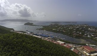 An aerial view of the U.S. Caribbean territory Saint Thomas, U.S. Virgin Islands, Wednesday, July 10, 2019. Ask about Jeffrey Epstein on St. Thomas and rooms go quiet. Some people leave. Those who share stories speak in barely audible tones.   (AP Photo/Gianfranco Gaglione )