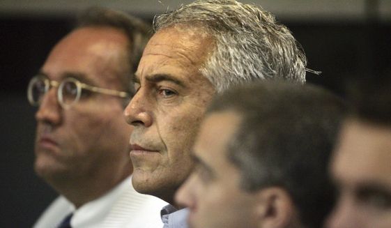 In this July 30, 2008, file photo, Jeffrey Epstein, center, appears in court in West Palm Beach, Fla. The wealthy financier pleaded not guilty in federal court in New York on Monday, July 8, 2019, to sex trafficking charges following his arrest over the weekend. Epstein will have to remain behind bars until his bail hearing on July 15. (Uma Sanghvi/Palm Beach Post via AP, File)