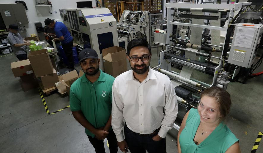 In this Friday, July 5, 2019, file photo Achyut Patel, Director of Operations, Rudy Patel, Director of Business Development an Katrina Hart, business development coordinator pose for a picture at beyond Green, a maker of biodegradable bags in Lake Forest, Calif. (AP Photo/Chris Carlson)