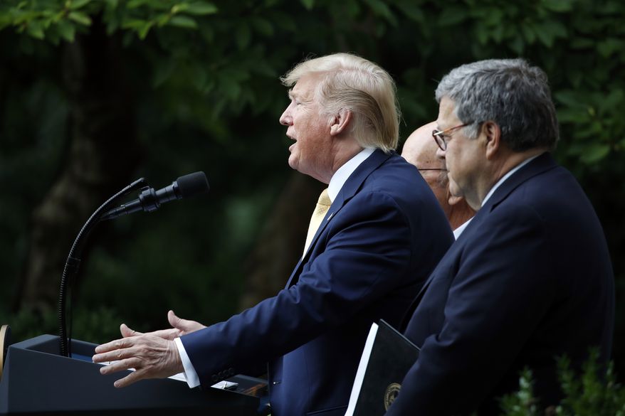 President Donald Trump is joined by Commerce Secretary Wilbur Ross and Attorney General William Barr, right, as he speaks in the Rose Garden at the White House in Washington, Thursday, July 11, 2019. (AP Photo/Alex Brandon)