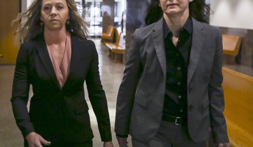 FILE--In this June 6, 2019, file photo, former Dallas police Officer Amber Guyger, left, walks the hallway at the Frank Crowley Courts Building in Dallas. Prosecutors have objected to Guyger's request that her murder trial for fatally shooting a neighbor in his own apartment be relocated. On Wednesday, July 10, 2019, a lawyer for the Dallas County District Attorney's office filed an objection to moving Guyger's trail for the killing of Botham Jean to another county. (Ryan Michalesko/The Dallas Morning News via AP, File)