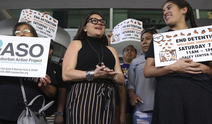 Mony Ruiz-Velasco, center, director of PASO West Suburban Action Project, chants with demonstrators following a new conference outside the U.S. Citizenship and Immigration Services offices in Chicago, Thursday, July 11, 2019. A nationwide immigration enforcement operation targeting people who are in the United States illegally is expected to begin this weekend. (AP Photo/Amr Alfiky)