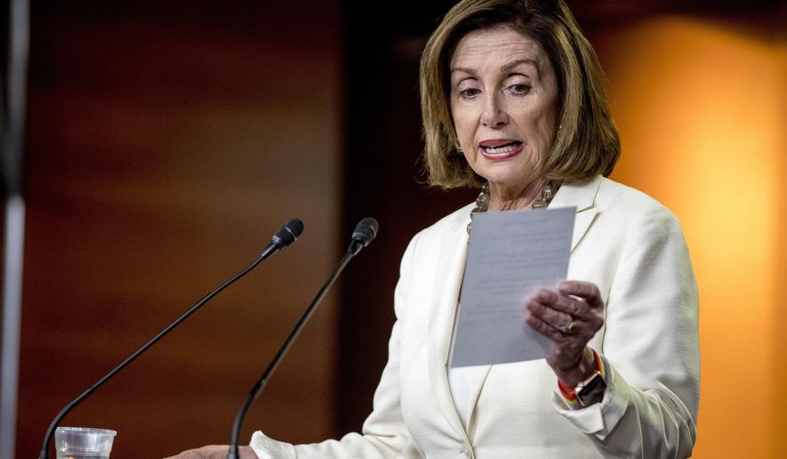 House Speaker Nancy Pelosi of Calif. reads from a paper titled "Know Your Rights" regarding ICE agents attempting to perform raids as she meets with reporters on Capitol Hill in Washington, Thursday, July 11, 2019. (AP Photo/Andrew Harnik)