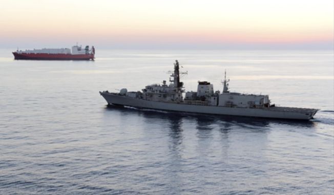 In this image from file video provided by U.K. Ministry of Defence, British navy vessel HMS Montrose escorts another ship during a mission to remove chemical weapons from Syria at sea off coast of Cyprus in February 2014. The British Navy said it intercepted an attempt on Thursday, July 11, 2019, by three Iranian paramilitary vessels to impede the passage of a British commercial vessel just days after Iran’s president warned of repercussions for the seizure of its own supertanker. A U.K. government statement said Iranian vessels only turned away after receiving “verbal warnings” from the HMS Montrose accompanying the commercial ship through the narrow Strait of Hormuz. (UK Ministry of Defence via AP)