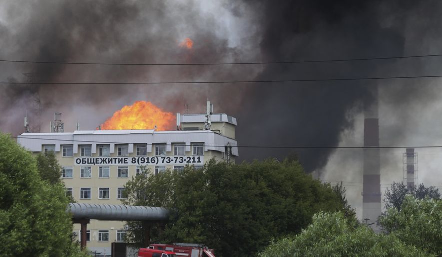 Black smoke and flames rise over a power station, in Mytishchi, outside Moscow, Russia, Thursday, July 11, 2019.The fire broke out on Thursday on the premises of a power station just outside Moscow, injuring five people. ( Sergey Vedyashkin, Moscow News Agency photo via AP)