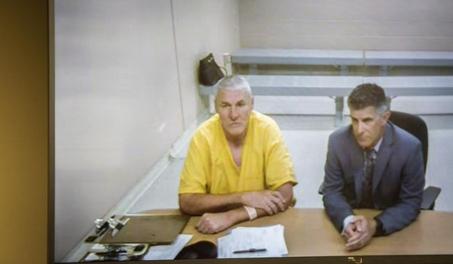 Former Washington State quarterback and Superbowl MVP Mark Rypien appears alongside defense attorney Chris Bugbee via video conference for a hearing presided over by commissioner Kristin O&#x27;Sullivan on Monday, July 1, 2019, in Spokane, Wash. Rypien was arrested yesterday for alleged fourth degree domestic violence against his wife, and is slated for release today without a no contact order. (Libby Kamrowski/The Spokesman-Review via AP)