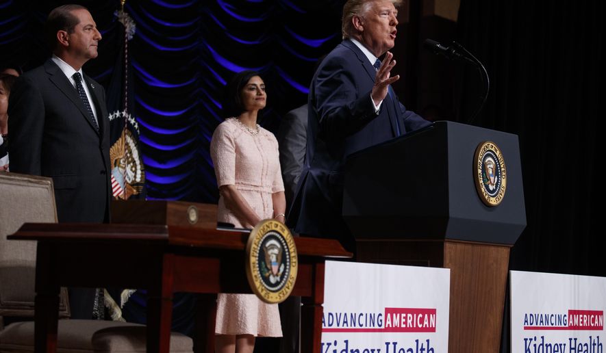 Secretary of Health and Human Services Alex Azar and administrator of the Centers for Medicare and Medicaid Services Seema Verma look on as President Donald Trump speaks during an event on kidney health at the Ronald Reagan Building and International Trade Center, Wednesday, July 10, 2019, in Washington. (AP Photo/Evan Vucci)