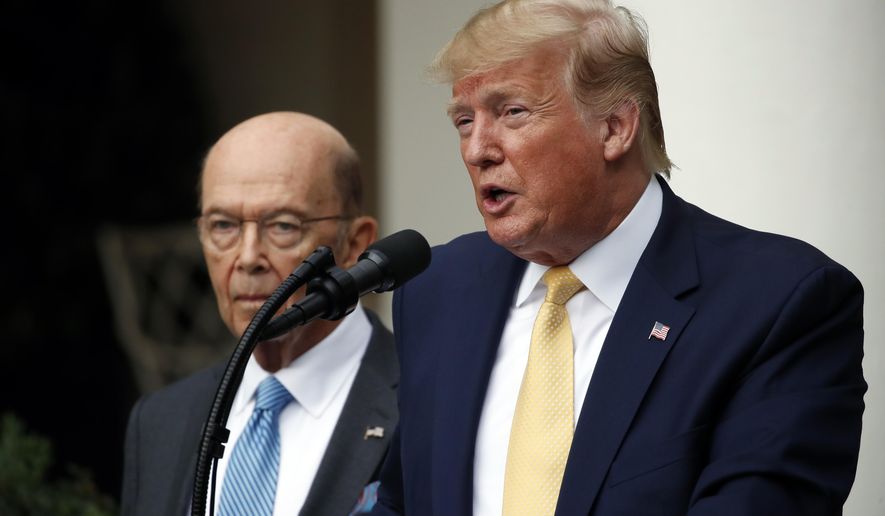 President Donald Trump is joined by Commerce Secretary Wilbur Ross as he speaks in the Rose Garden at the White House in Washington, Thursday, July 11, 2019. (AP Photo/Alex Brandon)