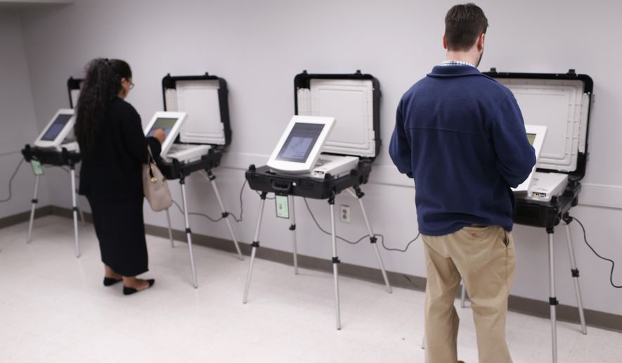 In this Dec. 4, 2018, file photo, locals cast their vote in Georgia&#39;s runoff election at the Lake Park Community Center in Athens, Ga. (Joshua L. Jones/Athens Banner-Herald via AP, File)