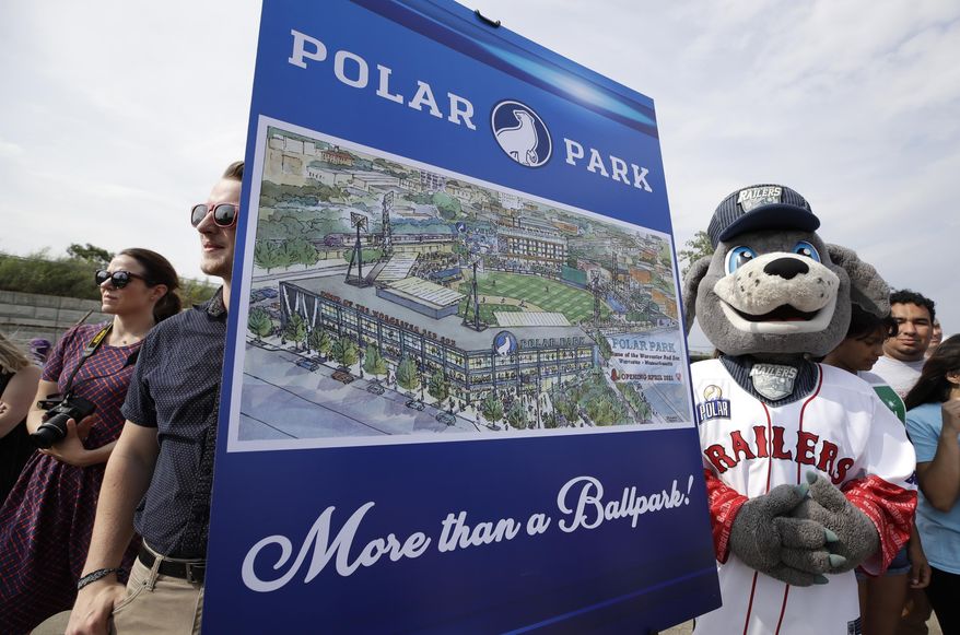 Spectators watch near an artist's rendering during a groundbreaking ceremony for a new minor league baseball stadium, Thursday, July 11, 2019, in Worcester, Mass. Polar Park will be the new home of the Boston Red Sox' Triple-A affiliate, beginning in 2021. The club announced last year that it is moving from Pawtucket, R.I. to Worcester after failing to reach a deal for a new stadium with Rhode Island officials. (AP Photo/Elise Amendola)