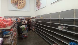 The bread section Friday afternoon at a Wal-Mart outside New Orleans has been picked over as shoppers swarm the giant retailer for supplies while bracing for Tropical Storm Barry. The storm, predicted to reach hurricane strength before making landfall, is scheduled to hit the Louisiana coast near Morgan City later Friday. (The Washington Times/James Varney)
