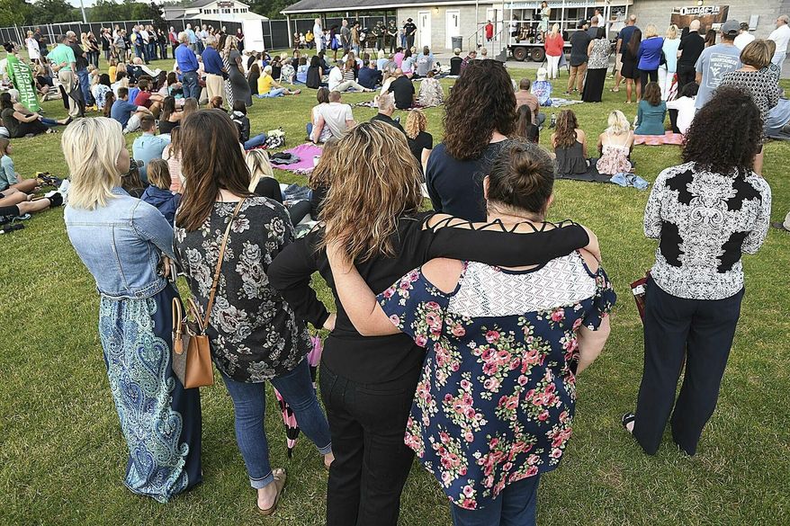 People attend a prayer vigil for the victims of the helicopter accident Thursday, July 11, 2019 at the Paul Cline Memorial Sports Complex in Beckley, W.Va. Chris Cline, his daughter Kameron Cline, Beckley native Delaney Wykle and four others were killed last week when their helicopter crashed after taking off from a remote private island in the Bahamas. (Rick Barbero/The Register-Herald via AP)
