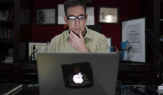 In this July 10, 2019 photo, U.S. journalist Glenn Greenwald checks his news website at his home in Rio de Janeiro, Brazil. Greenwald, an attorney-turned-journalist who has long been a free-speech advocate, has found himself at the center of the first major test of press freedom under Brazil&#39;s President Jair Bolsonaro, who took office on Jan. 1 and has openly expressed nostalgia for Brazil’s 1964-1985 military dictatorship, a period when newspapers were censored and some journalists tortured. (AP Photo/Leo Correa)